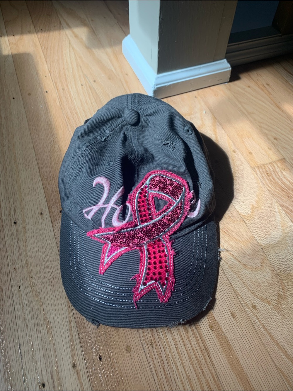 Grey baseball cap with pink ribbon and 'Hope' embroidery